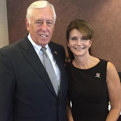 Hoyer stands with Anna Throne-Holst, the woman who helped fix their local finances and co-founded an elementary school to meet the needs of all students